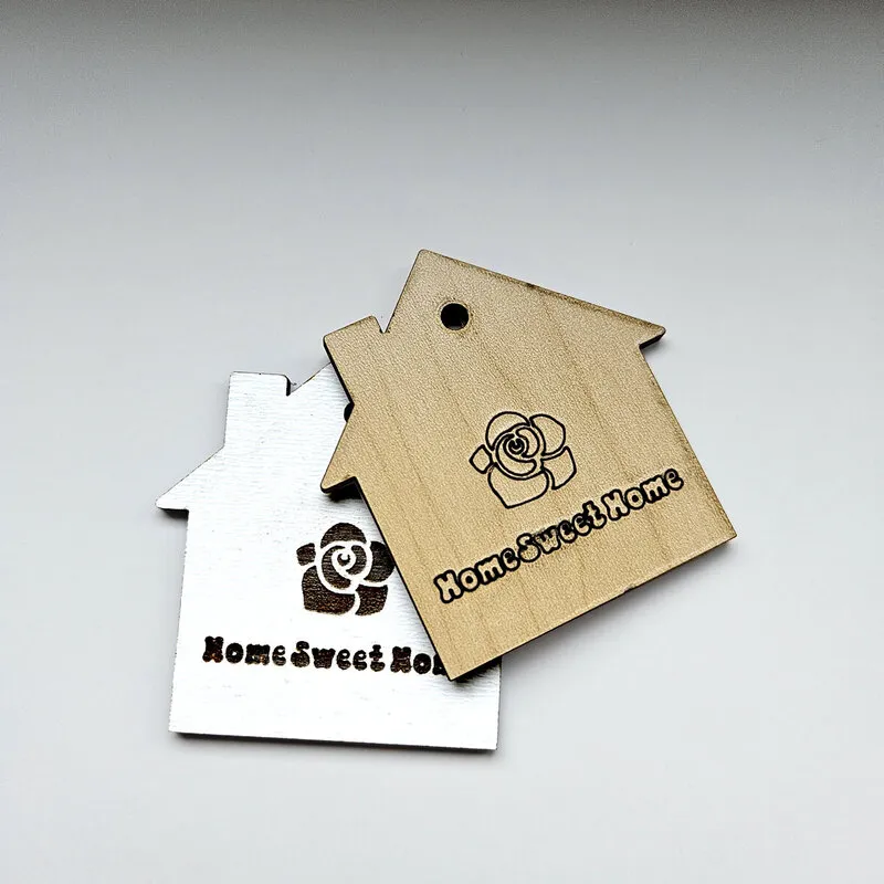 Laser-cut gift tag in the shape of a house, made from MDF core laser plywood.
